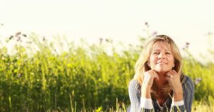 Happy,Middle,Age,Woman,With,Her,Head,On,The,Hands